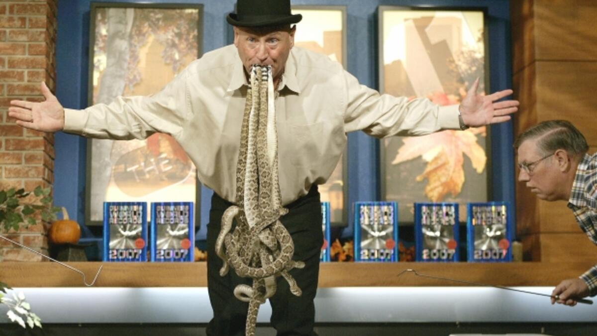 Jackie Bibby a.k.a. “The Texas Snakeman” holds in his mouth ten 2 ft 6-inch-long western diamondback rattlesnakes for 12.5 seconds without any assistance at the CW11 morning show on November 9, 2006 to set a new Guinness World Record for Most Live Rattlesnakes Held In Mouth. (AFP/ File Photo)