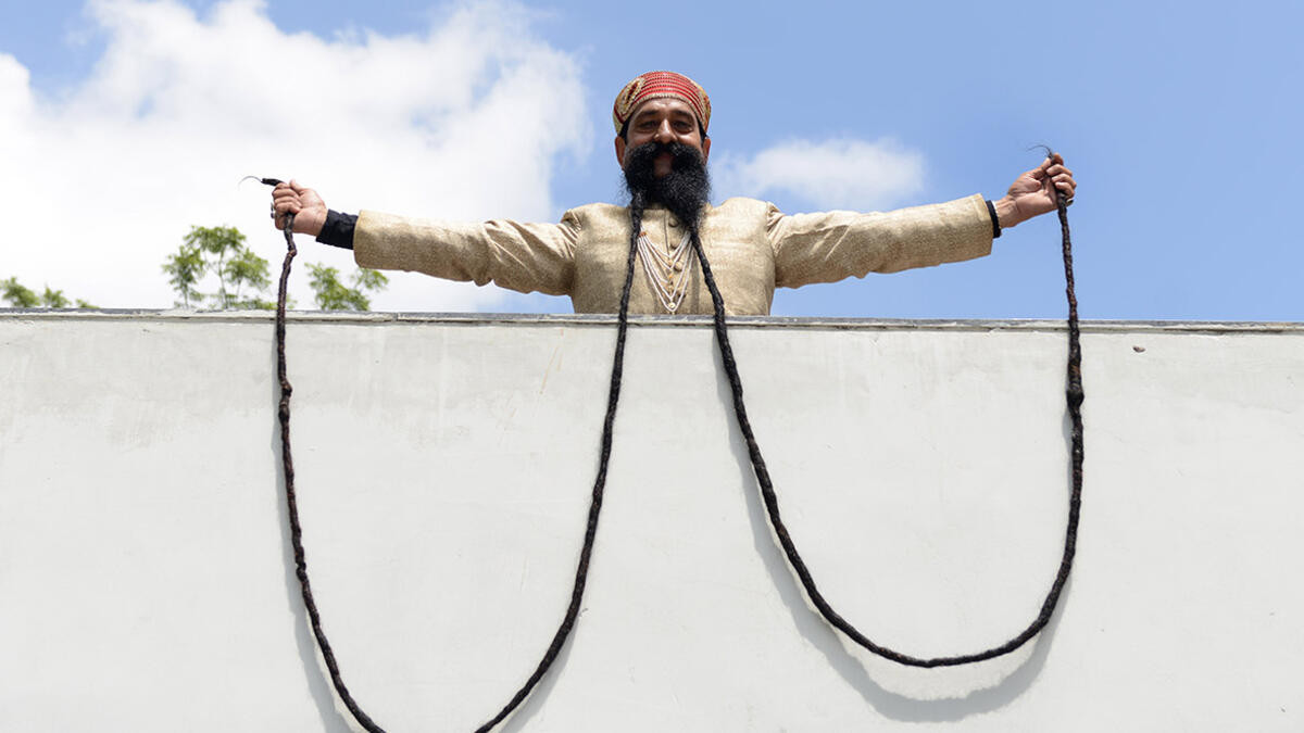 Ram Singh Chauhan (61) displays his 18ft moustache in Ahmedabad, India. It has been recognized by the Guinness Book of World Records as the world's longest moustache. (AFP/ File Photo)
