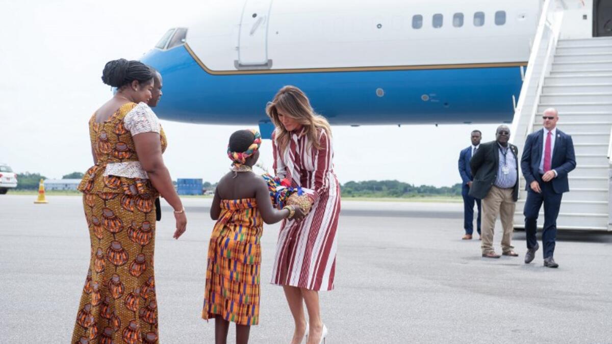 US First Lady Melania Trump receives flowers during an arrival ceremony after landing at Kotoka International Airport in Accra October 2, 2018 as she begins her week long trip to Africa to promote her 'Be Best' campaign.  (SAUL LOEB / AFP)