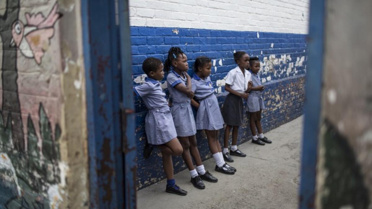 School girls play in a corridor of Mbuyisa Makhubu Primary School in the are of Orlando West, in the South African township of Soweto. (GULSHAN KHAN / AFP)