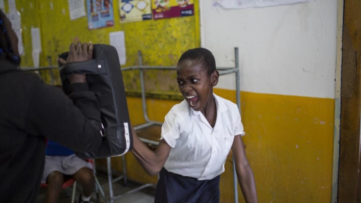 Girls practice self defence methods during a session with NGO Action Breaks Silence (ABS) called "Empowerment through Self-defence for Women and Girls" which aims to create a world free form fear of gender based violence. (GULSHAN KHAN / AFP)