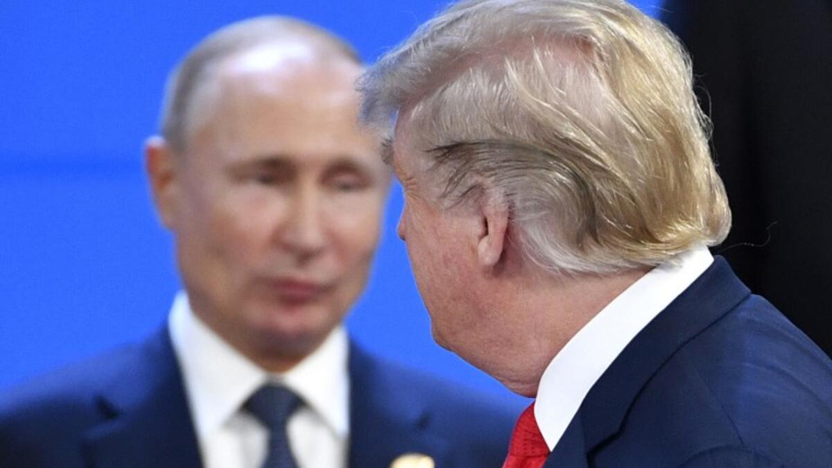 US President Donald Trump (R) looks at Russia's President Vladimir Putin as they take their places for a family photo, during the G20 Leaders' Summit in Buenos Aires.
Alexander NEMENOV / AFP