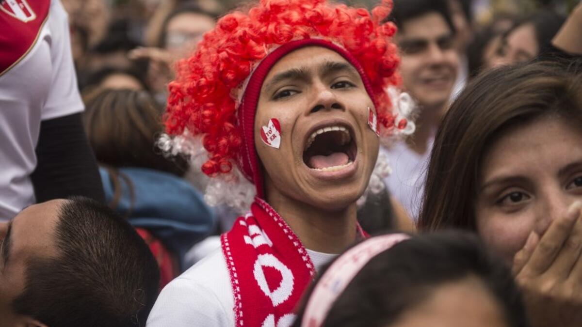 Peruvian football fans react as they watch their team's 2018 World Cup football match against Denmark on a big screen at a park in Lima, on June 16, 2018. 
ERNESTO BENAVIDES / AFP