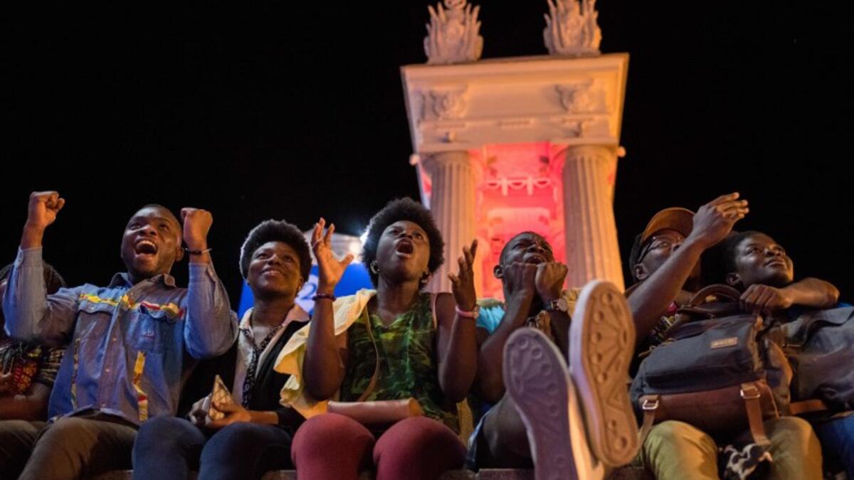 Nigerian football fans react as they watch the Russia 2018 World Cup Group D football match between Croatia and Nigeria on a giant screen at the official FIFA Fan Fest in Volgograd on June 16, 2018. 
NICOLAS ASFOURI / AFP