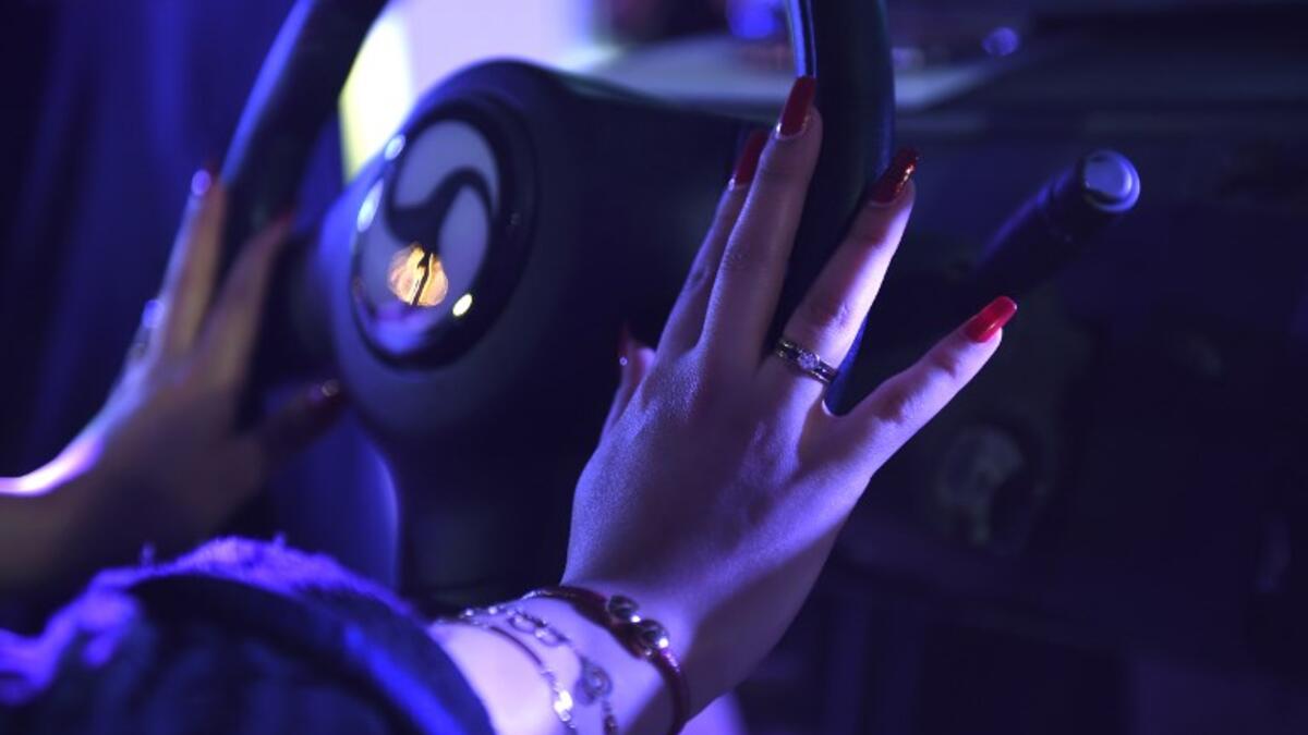 A Saudi woman uses a driving simulator during a driving workshop for women in the Saudi capital Riyadh on June 21, 2018. 
FAYEZ NURELDINE / AFP