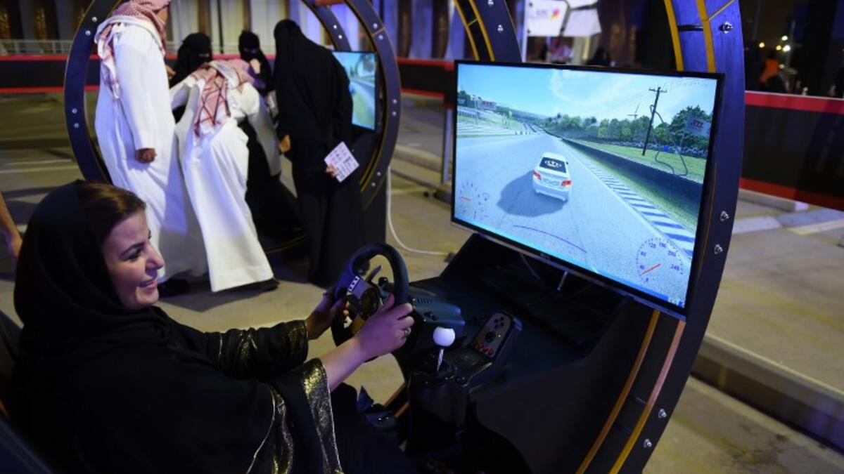 A Palestinian woman residing in Saudi Arabia uses an electronic driving simulator during a go-cart driving workshop for women in the Saudi capital Riyadh on June 21, 2018. 
FAYEZ NURELDINE / AFP