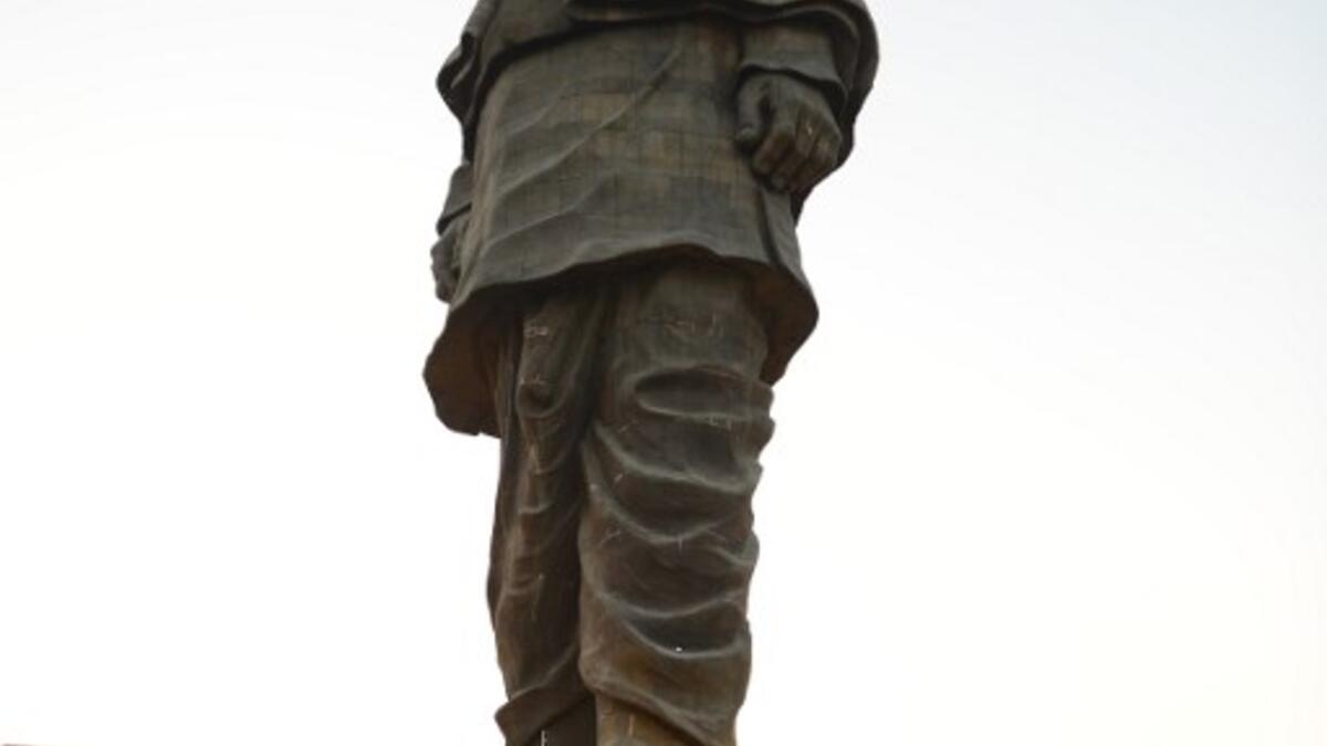 Indian construction workers are seen near the "Statue Of Unity", the world's tallest statue dedicated to Indian independence leader Sardar Vallabhbhai Patel. (SAM PANTHAKY / AFP)