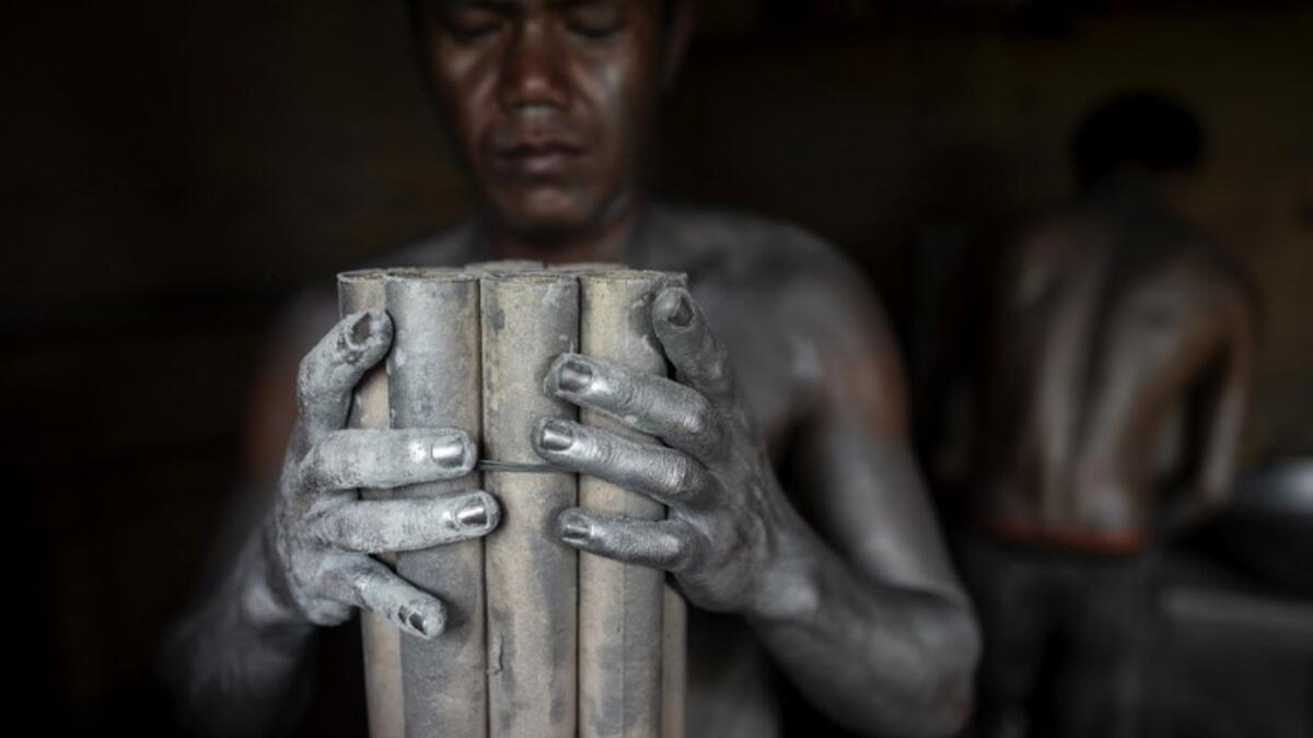 Workers covered with gunpowder material make fireworks for New Year celebrations in Bocaue, Bulacan, north of Manila on December 26, 2018. 
Noel CELIS / AFP