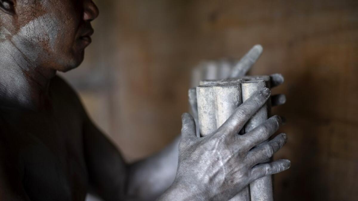 A worker covered with gunpowder material makes fireworks for New Year celebrations in Bocaue, Bulacan, north of Manila on December 26, 2018. 
Noel CELIS / AFP