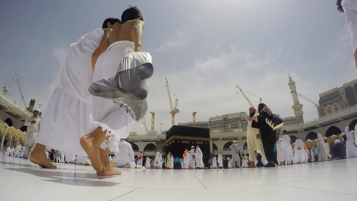 Two brothers among thousands of pilgrims perform the Tawaf. Tawaf around the Kaaba of 7 times (Shutterstock/File Photo)