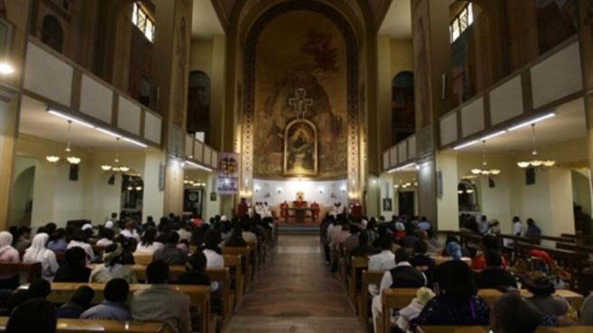 Libya: Christian residents in the country gather to take refuge in Easter solemnities. A Christian Catholic priest kisses the crucified statue of Jesus during Good Friday service.