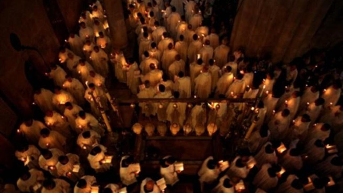 Holy tomb at Jerusalem: Greek Orthodox Patriarch Theofilos III begins the ceremony inside the Holy Sepulchre, the place where Christians believe Jesus was buried.