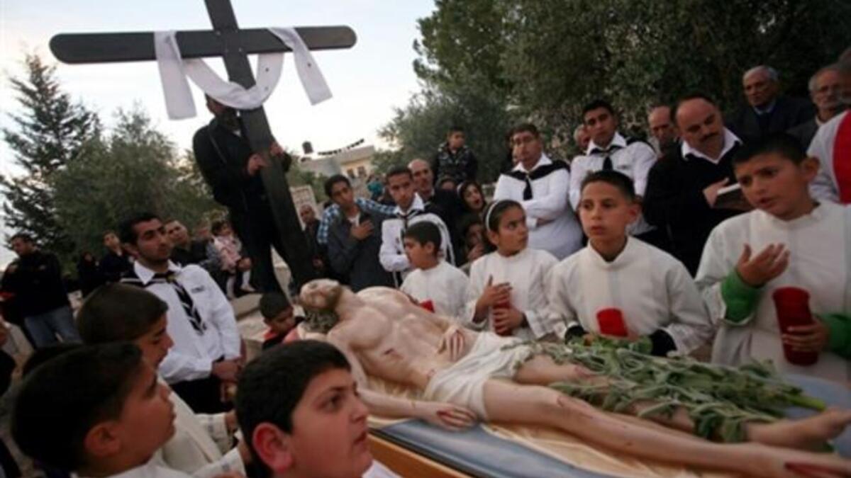 Jesus at Jenin: Palestinian Christians carry a statue of Jesus Christ during the Good Friday procession in the West Bank village of Zababdi.