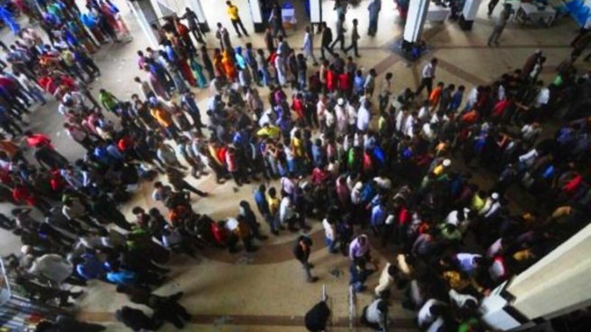 Bangladesh: Bangladeshi travellers queue to collect tickets at a railway station in Dhaka, ahead of the Muslim festival of Eid Al-Fitr. City workers make their way home for the holiday.