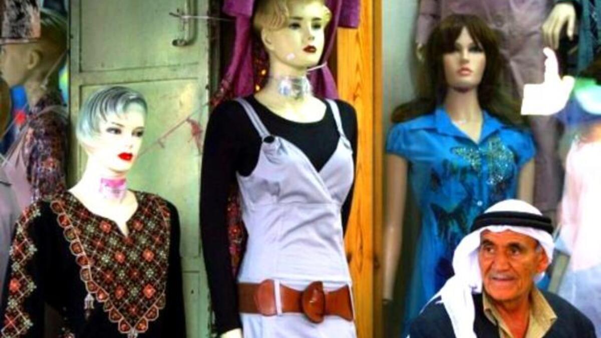 Palestinian preparations: In the West Bank city of Hebron, following universal Eid custom, Muslims buy new clothes for Eid. Often they can use their 'Eidiyeh' (the money gifts traditionally bestowed upon child members of the family - especially from grandparents) to buy new clothes or treats.