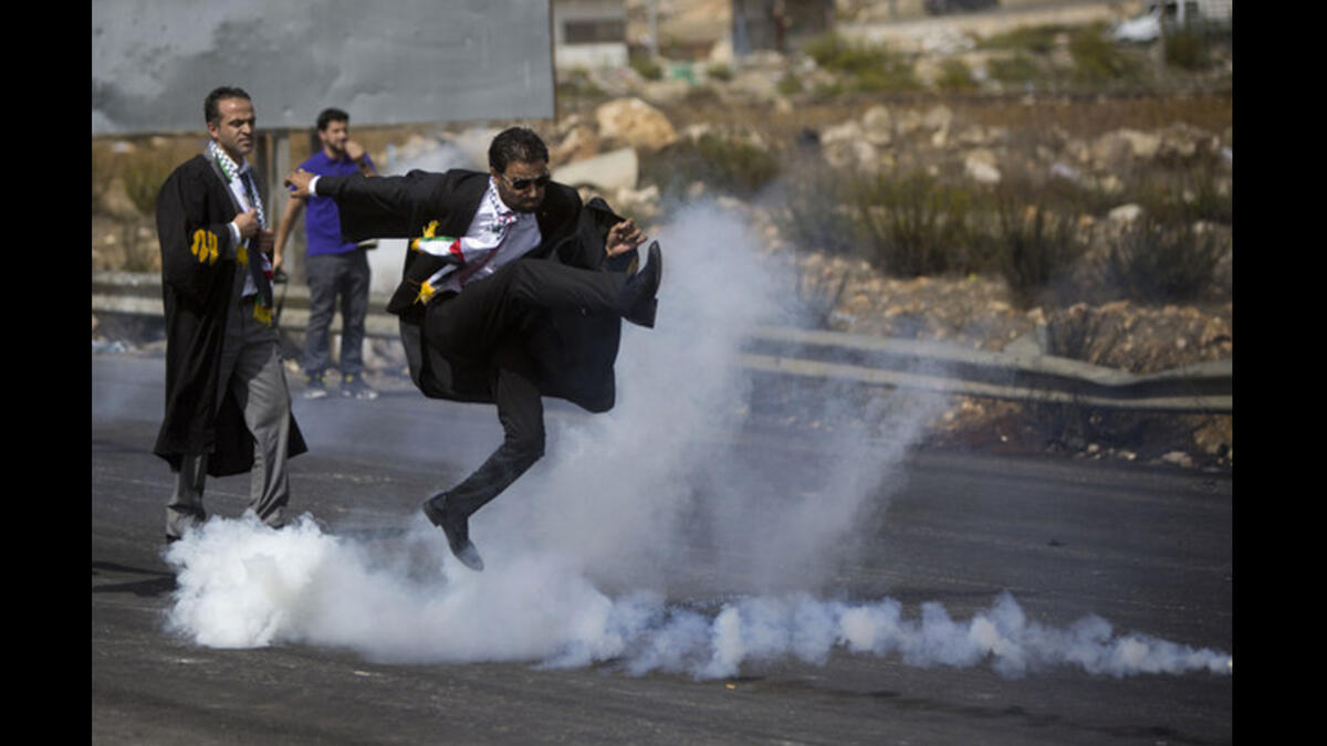 palestinian lawyer kicks tear gas can