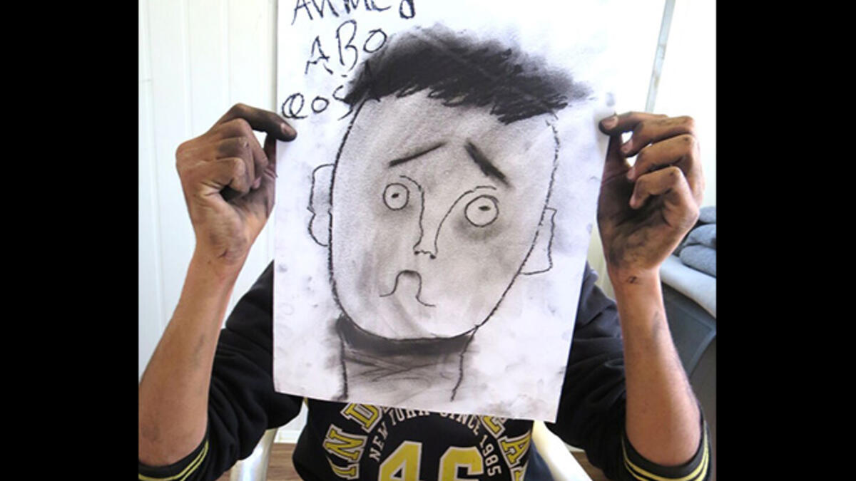 Ahmed nailed the eyebrow lesson, perfectly communicating confusion in his over-sized self portrait. By the end of this session, the black charcoal drawing sticks left the crew looking like coal-miners.
