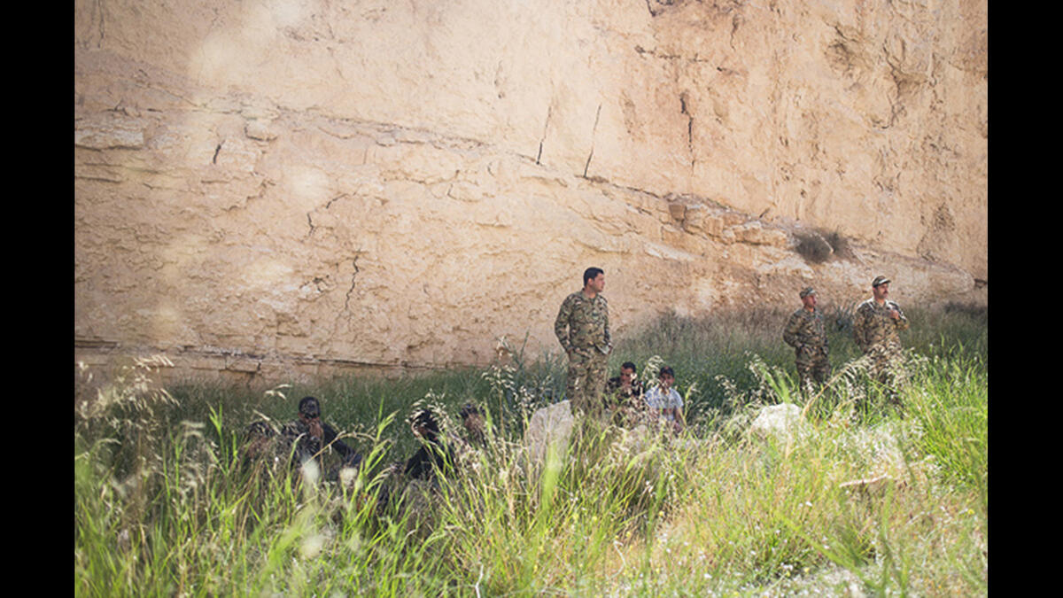 Jordan's team rests in the shade of a sandstone cliff before the Warrior Competition "urban assault" event where soldiers rush over a dirt verge, storm a building in a mock city, and rescue a hostage. Jordan's special forces have joined the ongoing fight against Daesh, when a militant cell was uncovered in northern city, Irbid.