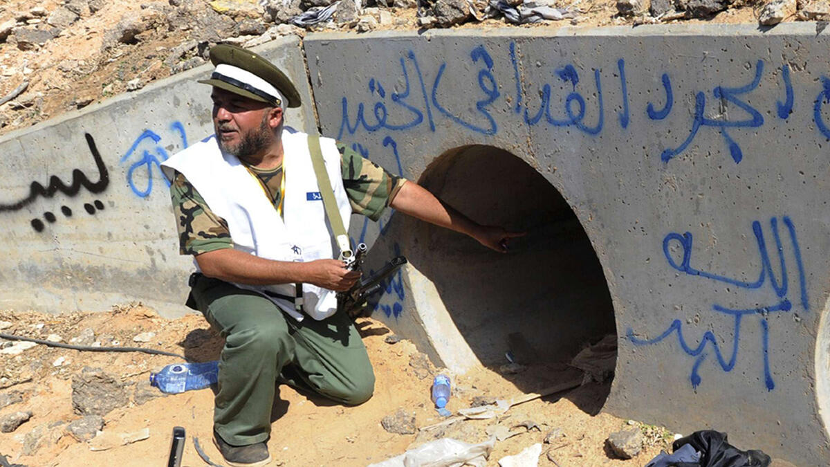 Gaddafi takes shelter in a drainpipe, but rebel fighters soon catch up with him and drag him to the street. Amateur video shows rebels sodomizing him with a pole or a knife. Gaddafi dies of bullet wounds soon thereafter, but it’s unclear who killed him.