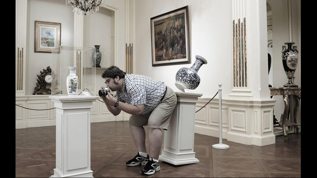man breaking vase