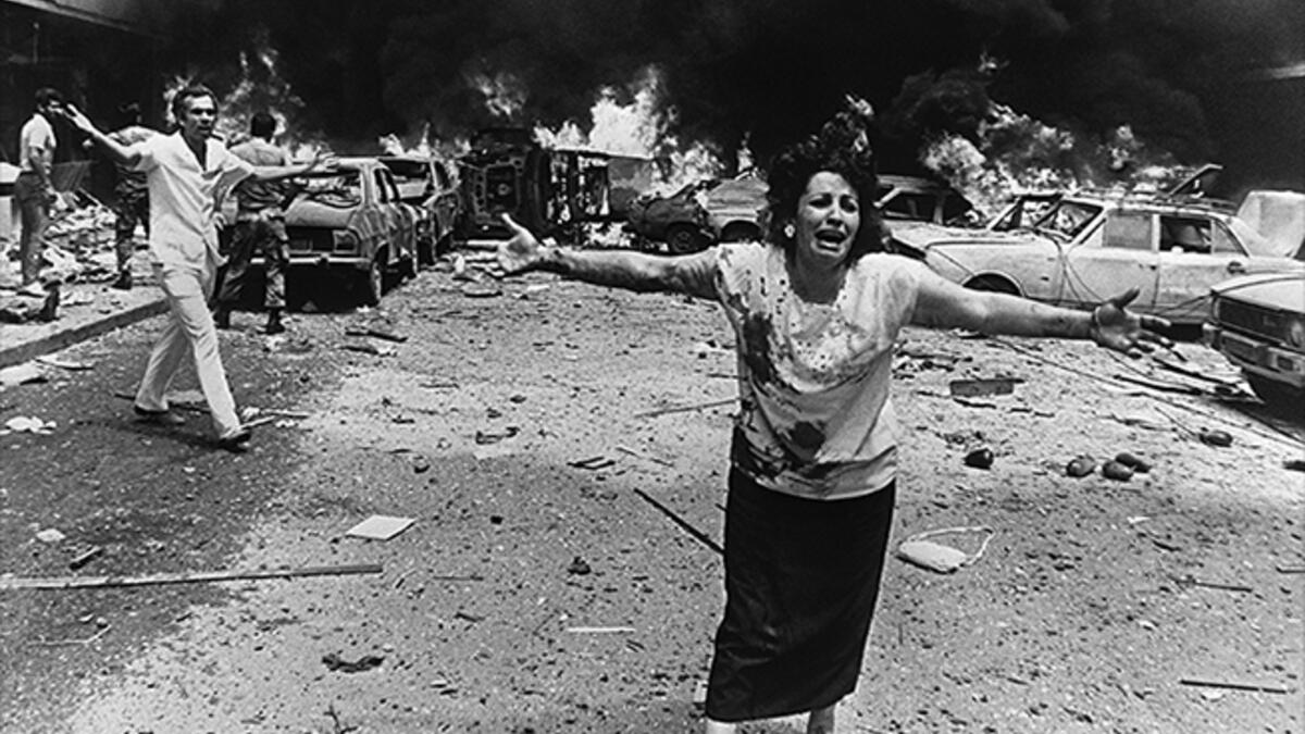 August 8, 1986,Tariq al-Jdideh, Lebanon - A woman screams out for her children after a bomb explosion during the 15-year-long Lebanese Civil War that killed some 170,000 people. This image illustrated the sheer chaos of the conflict, a reality the Lebanese are reminded of today by the bombed out buildings and bullet holes left behind.