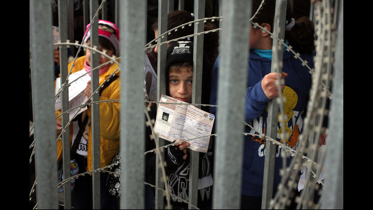 palestinian children barbed wire checkpoint