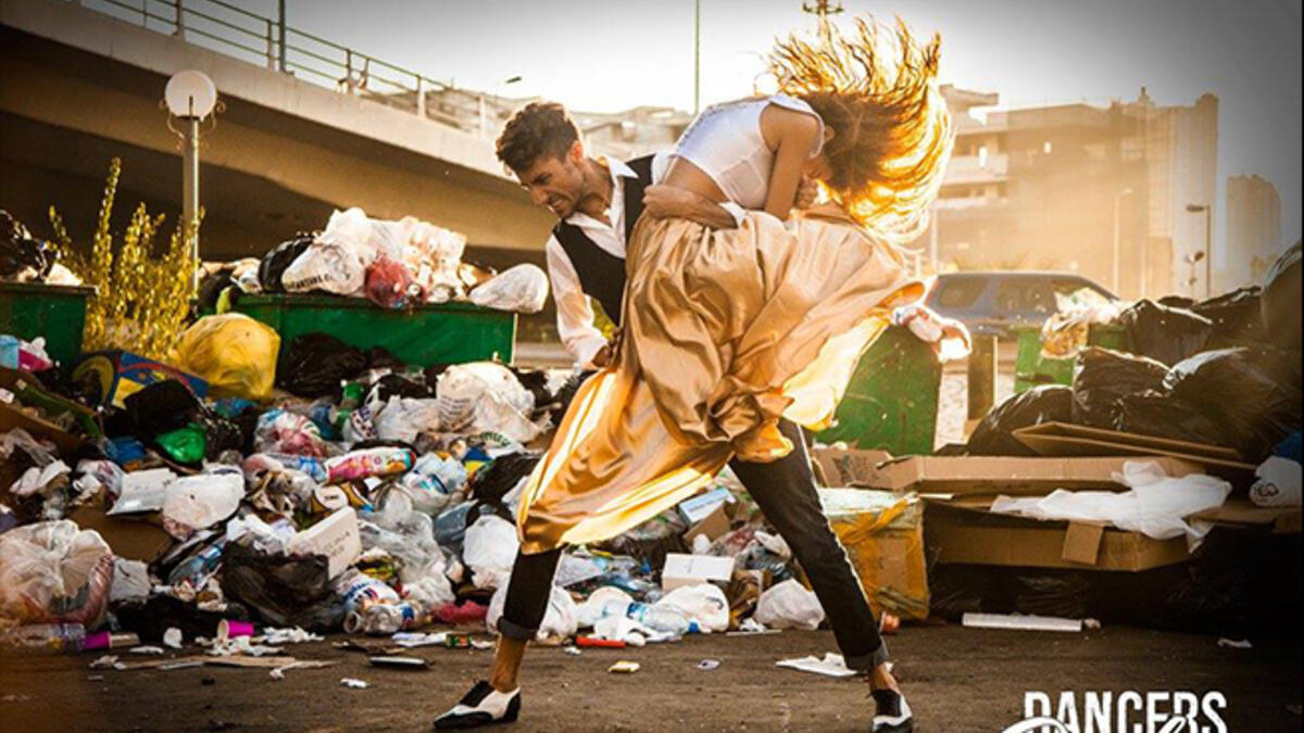beirut dancers in front of trash heaps