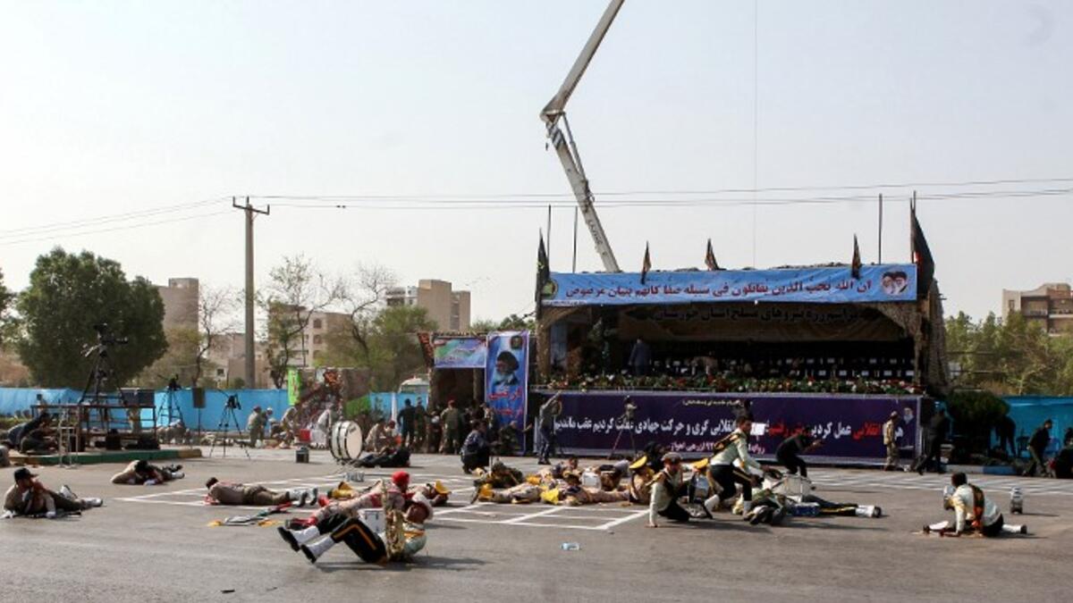 This picture taken on September 22, 2018 in the southwestern Iranian city of Ahvaz shows injured soldiers lying on the ground at the scene of an attack on a military parade. (Alireza MOHAMMADI / ISNA / AFP)