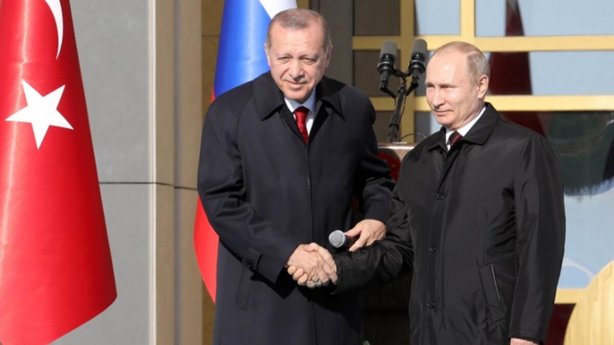Famous handshake to remember as both Erdogan and Putin cement a working nuclear relationship, 3 April, (ADEM ALTAN / AFP)