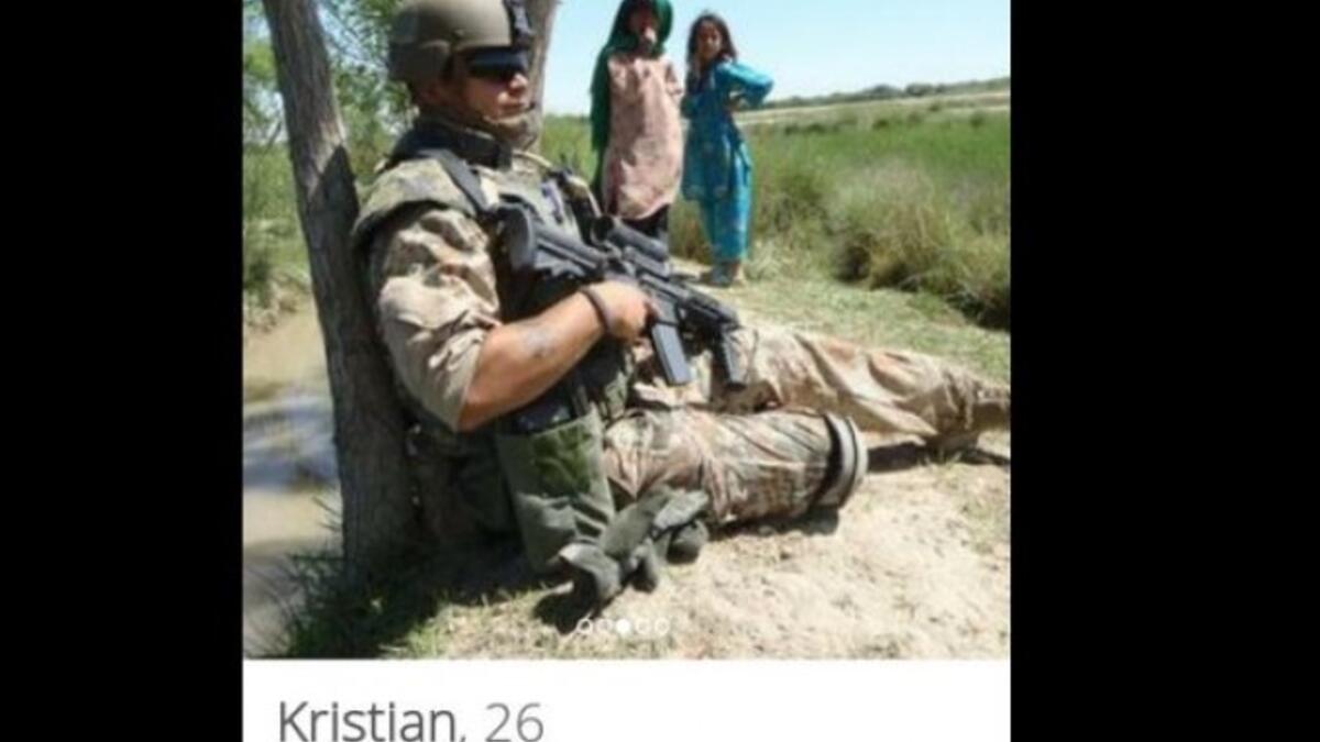 armed soldier posed near little Arab girls