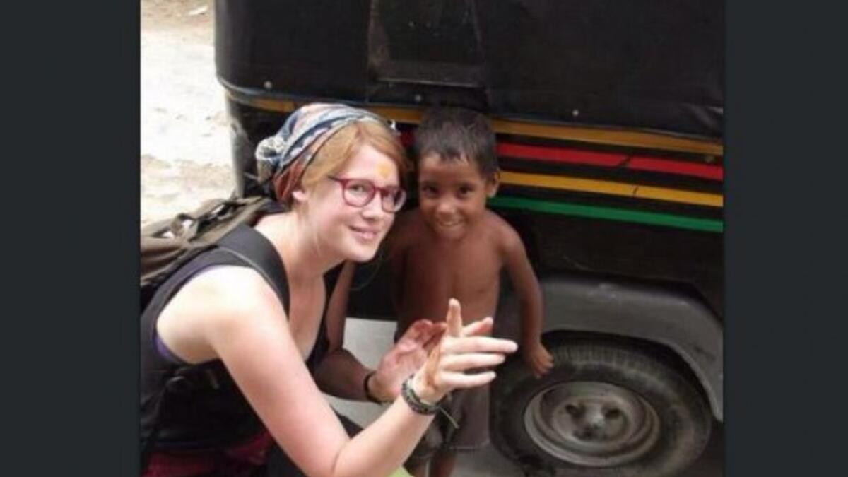 aid worker posing with foreign child