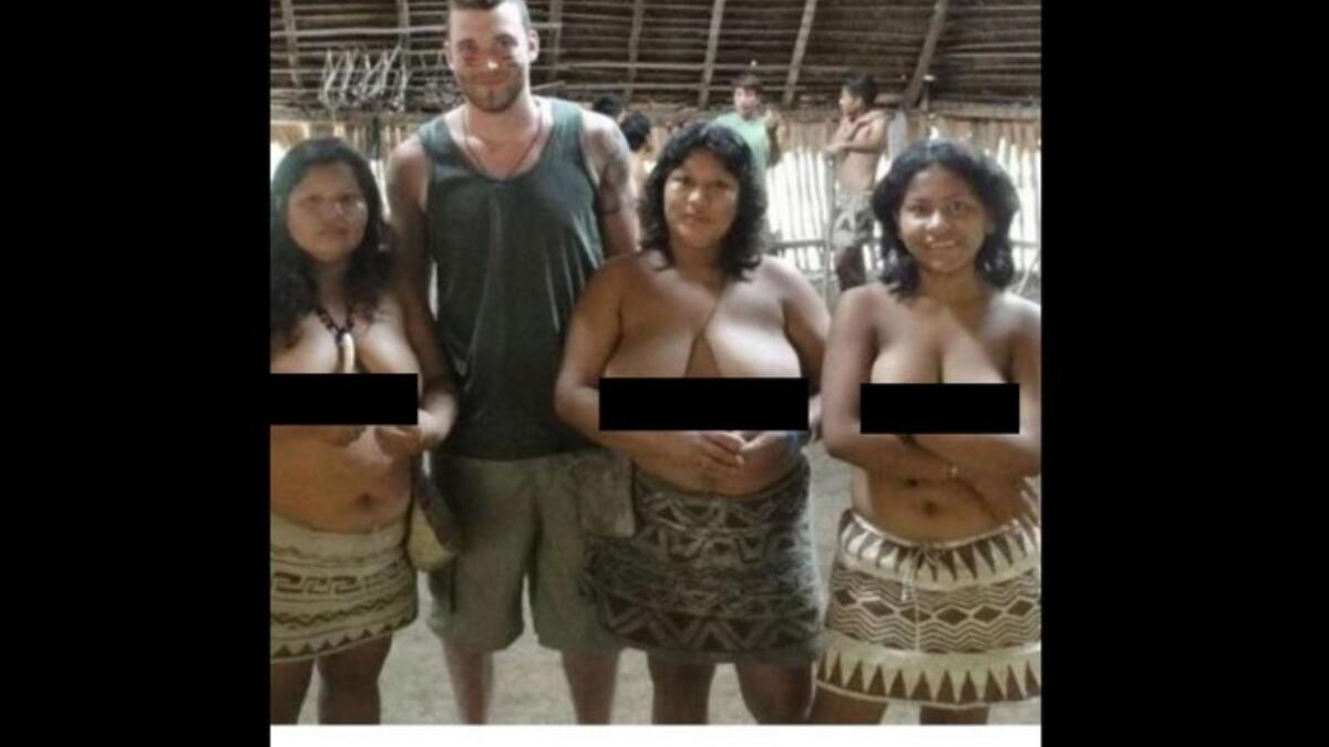 white man with bare-breasted indian women