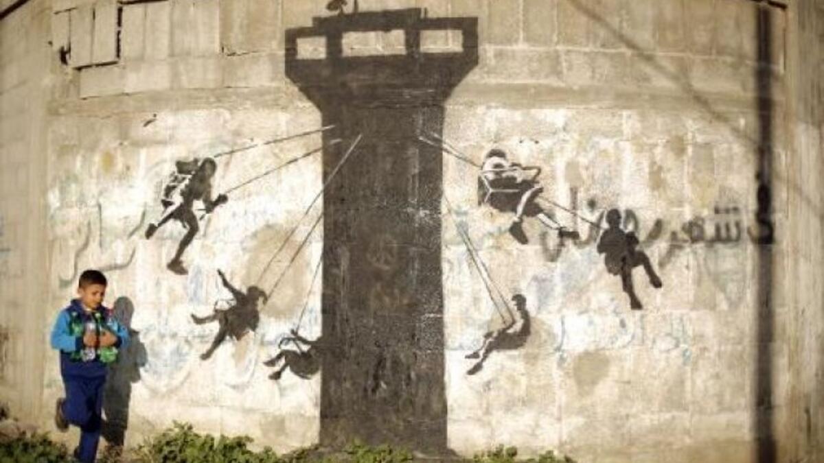 This graffiti is a carousel of children, in Banksy's typical stencil technique /AFP