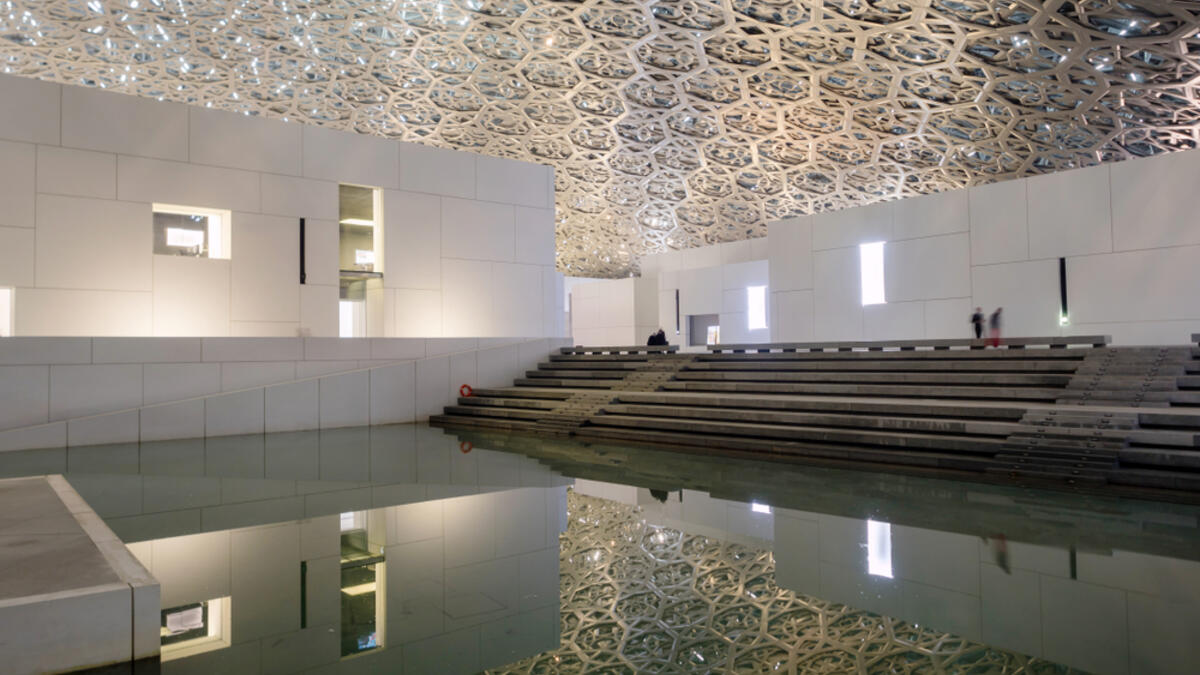 The Louvre museum with modern design exterior luminated at night (Shutterstock/File Photo)