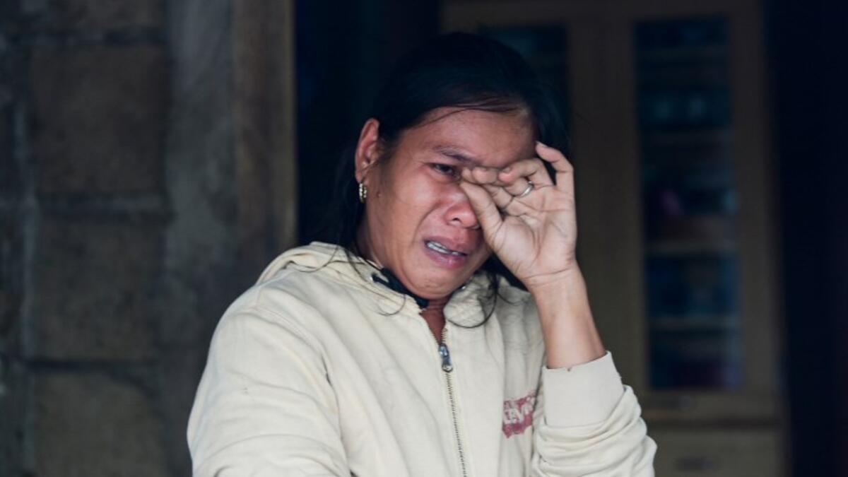 A woman weeps as she talks about her family's experience at the height of Super Typhoon Mangkhut in the town of Baggao, Cagayan province on September 15, 2018.TED ALJIBE / AFP
