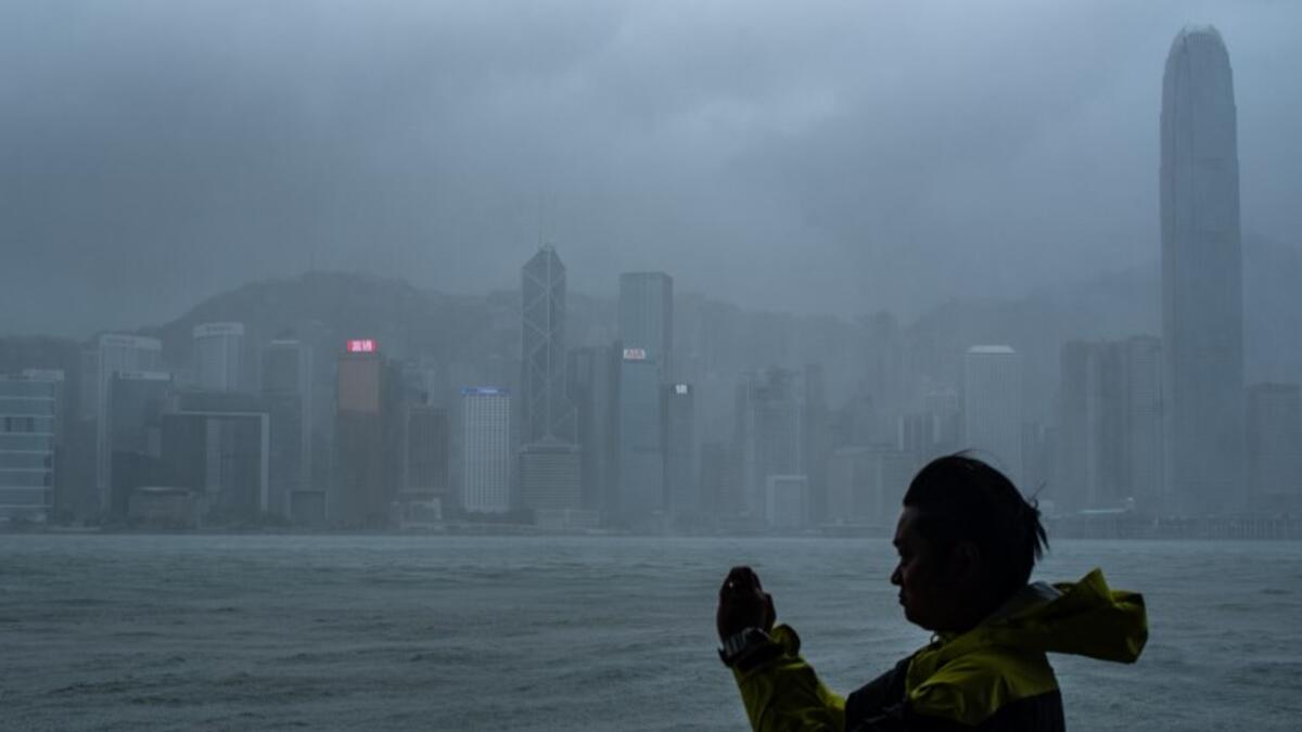 A man takes photos during the approach of super Typhoon Mangkhut to Hong Kong on September 16, 2018 .
Philip FONG / AFP