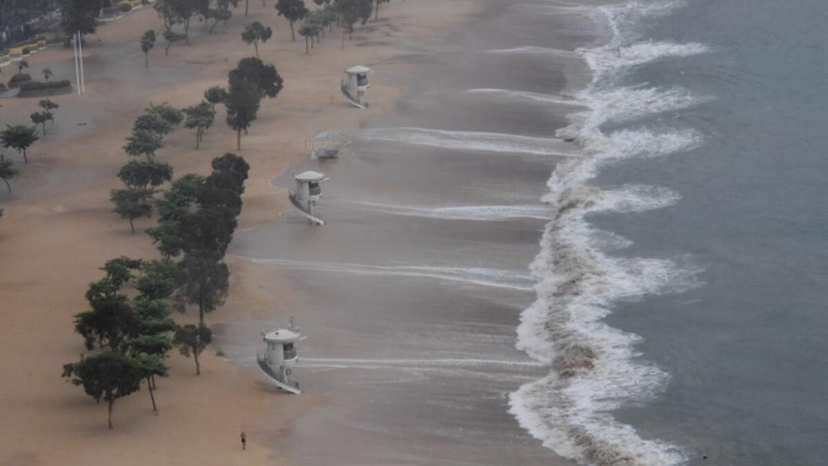 A man jogs along Repulse Bay beach after the hoisting of signal number 9 warning as super Typhoon Mangkhut starts to slam Hong Kong on September 16, 2018. 
Mark RALSTON / AFP