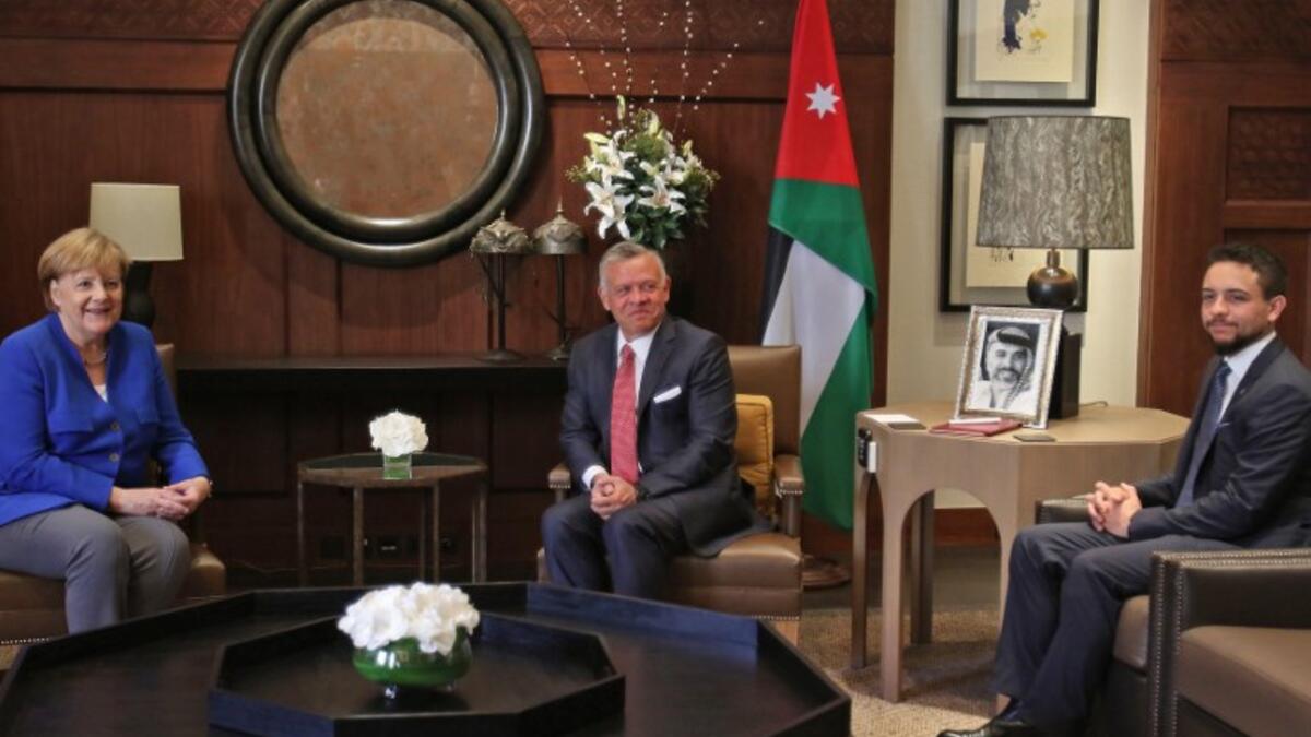 Jordanian King Abdullah II, Crown Prince Hussein bin Abdullah welcome German Chancellor Angela Merkel at the Jordan Royal Palace in Amman, June 21, 2018. (AFP/Khalil Mazraawi)