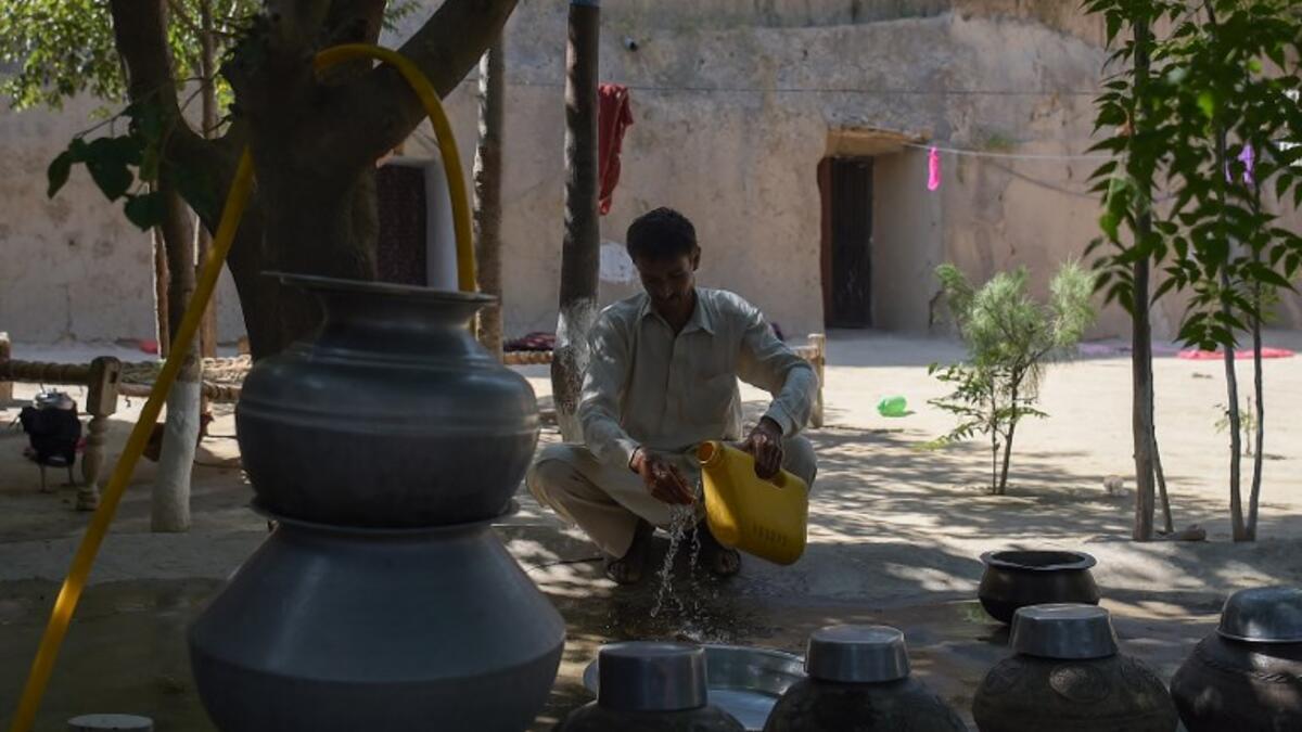 Pakistani villager Ameer Ullah Khan washes his hands outside his cave home in Nikko village.
AAMIR QURESHI / AFP