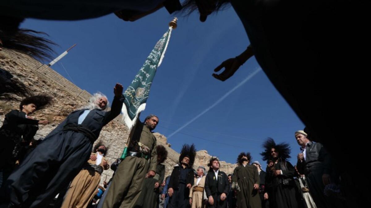 Iraqi Sufi Muslim Kurds take part in a ritual ceremony to commemorate the birth of the Prophet Mohammed in .
Akra.
SAFIN HAMED / AFP