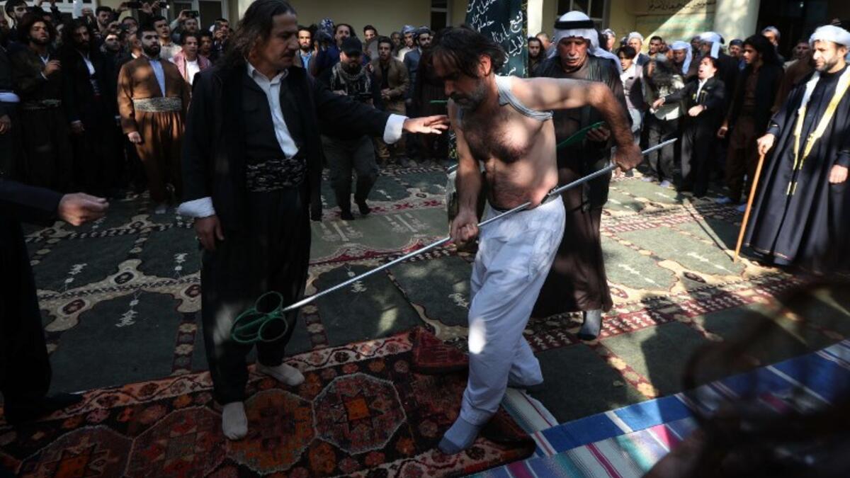 Iraqi Sufi Muslim Kurds take part in a ritual ceremony to commemorate the birth of the Prophet Mohammed  on November 19, 2018.
SAFIN HAMED / AFP