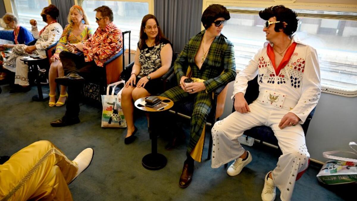 Elvis fans sit on a train after leaving Central station to head to The Parkes Elvis Festival, in Sydney on January 10, 2019. The Parkes Elvis Festival is an annual event celebrating the music and life of Elvis Presley in the New South Wales town of Parkes.
PETER PARKS / AFP