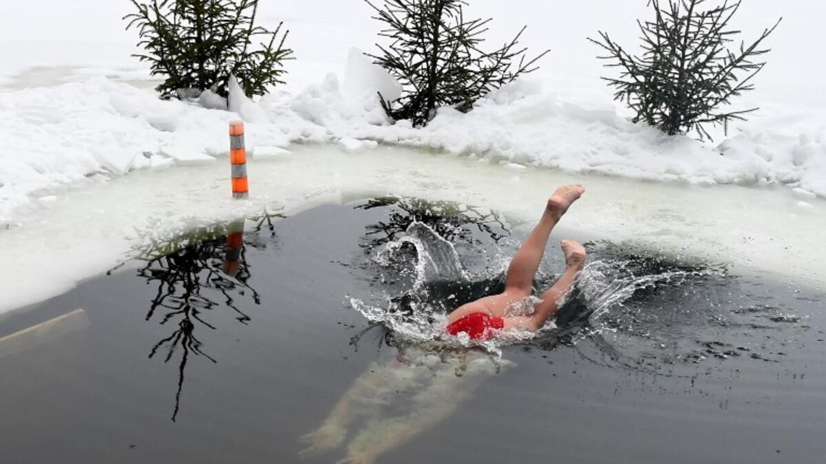 An ice swimmer dives into the icy waters of the Moscow River on February 3, 2019. 
Kirill KUDRYAVTSEV / AFP