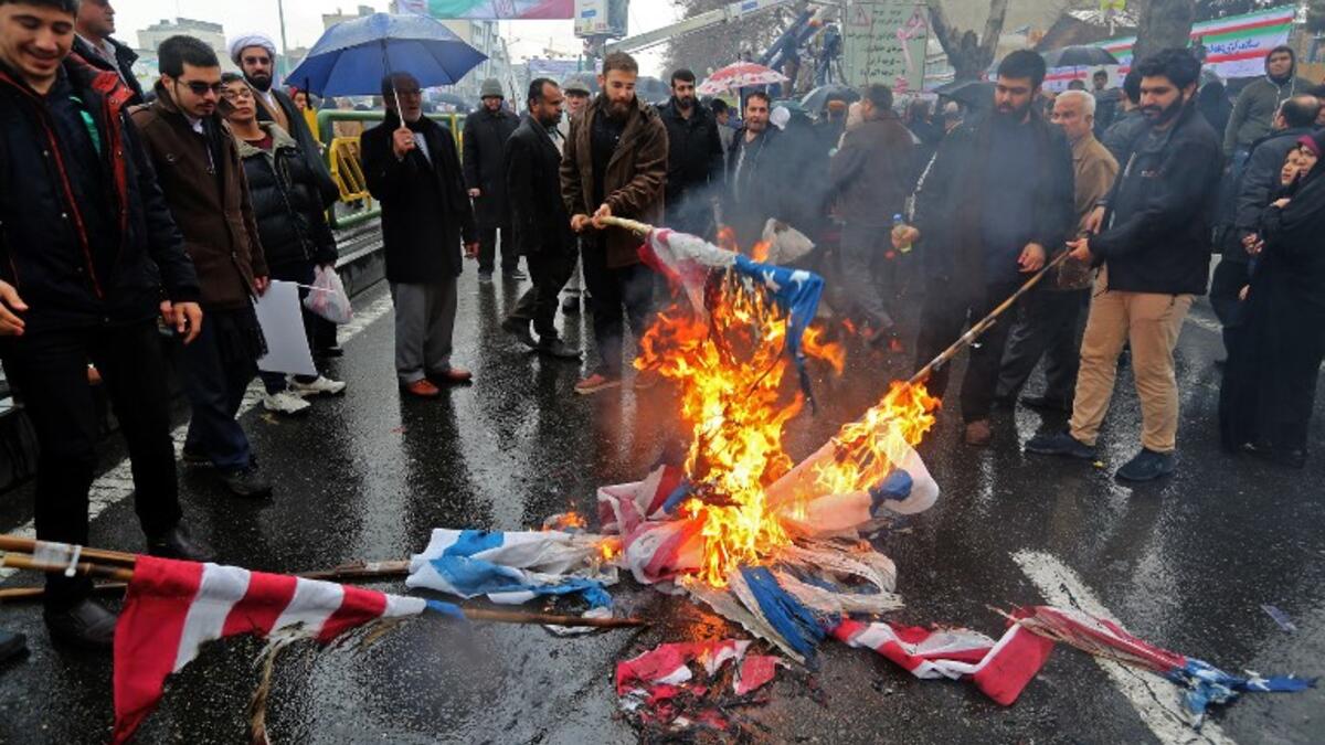 Iranians burn flags of Israel and the United States during commemorations of the 40th anniversary of Islamic Revolution in the capital Tehran on February 11, 2019. 
ATTA KENARE / AFP