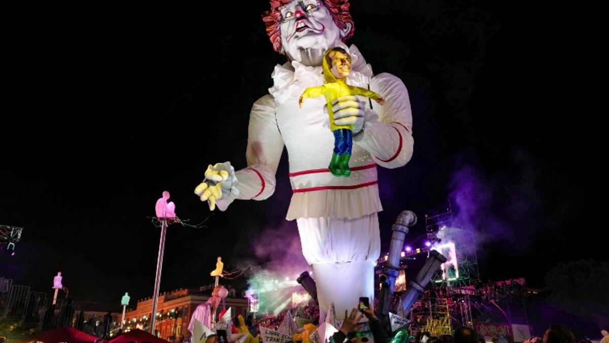 A carnival float with a giant statue of US President Donald Trump depicted as an evil clown holding a French President Emmanuel Macron's puppet in his hand parade on the first day of the 135th Nice Carnival.
VALERY HACHE / AFP