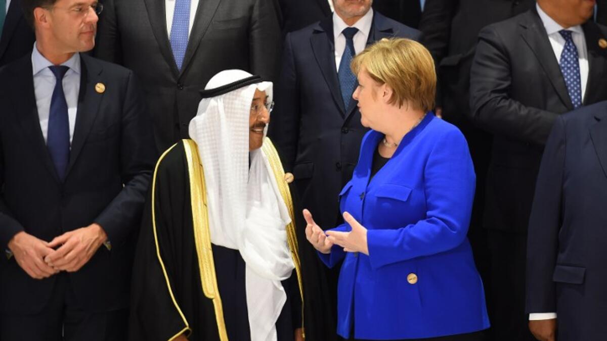 German Chancellor Angela Merkel (blue jacket) talks with Emir of Kuwait Sheikh Sabah al-Ahmad Al-Sabah (L) during the first joint European Union and Arab League summit at the International Congress Centre in the Egyptian Red Sea resort of Sharm el-Sheikh, on February 24, 2019. 
MOHAMED EL-SHAHED / AFP