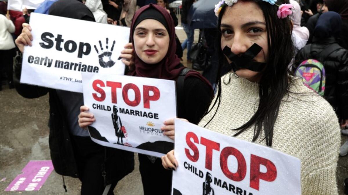 Lebanese women hold placards as they participate in a march against marriage before the age of 18, in the capital Beirut on March 2, 2019. 
ANWAR AMRO / AFP