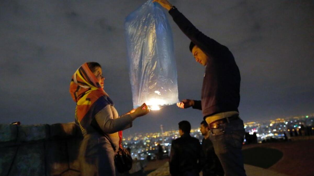 An Iranian couple lights a lantern in a park in Tehran on March 19 2018 during the Wednesday Fire feast, or Chaharshanbeh Soori, held annually on the last Wednesday eve before the Spring holiday of Noruz.
STRINGER / afp
