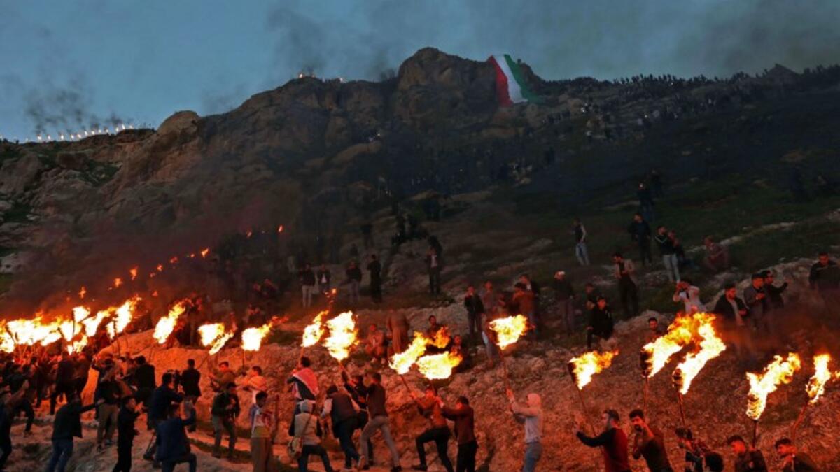 Iraqi Kurds holding lit torches walk up a mountain in the town of Akra, 500 kilometres north of Baghdad, on March 20, 2019 during celebrations of Nowruz (Noruz), the Persian New Year.
SAFIN HAMED / AFP