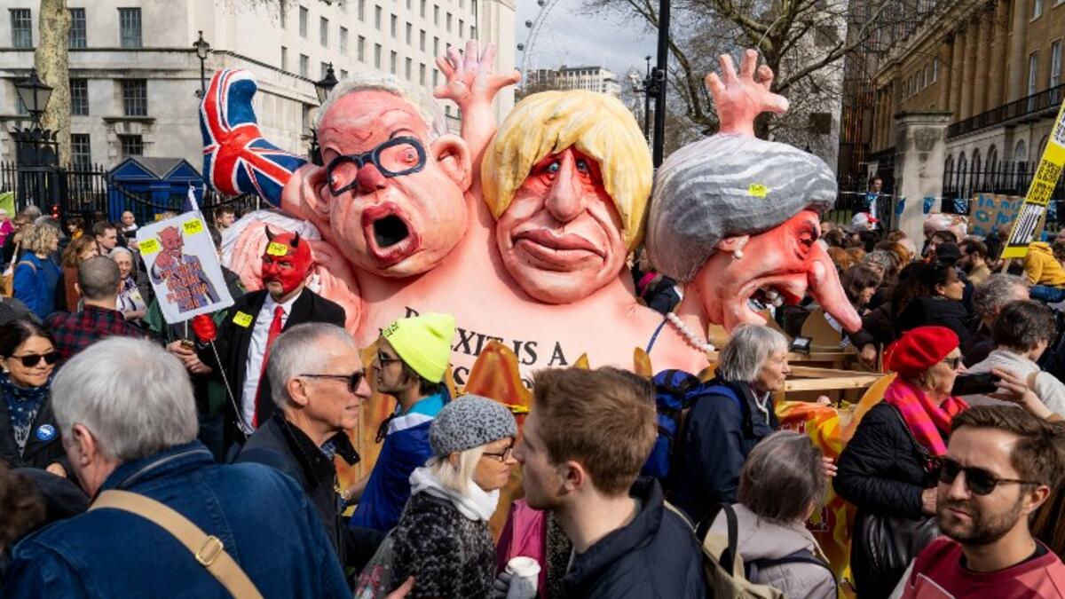 A combined model of (L-R) Britain's Environment, Food and Rural Affairs Secretary Michael Gove, Britain's former Foreign Secretary Boris Johnson and Britain's Prime Minister Theresa May is seen at a rally in central London on March 23, 2019. 
Niklas HALLE'N / AFP